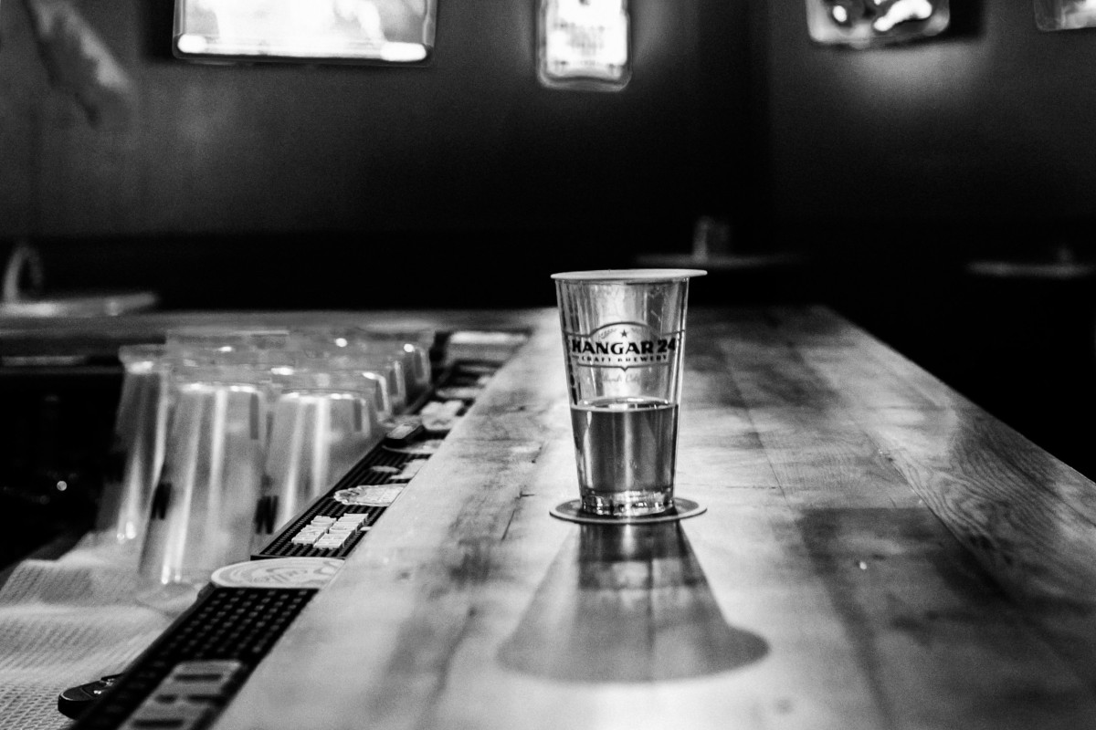 A shot glass on the bar, black and white